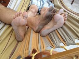 dirty male feet on hammock