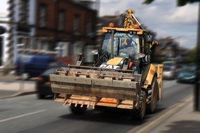 Riding bulldozer car on a road