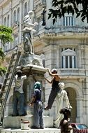 workers near the sculpture in havana