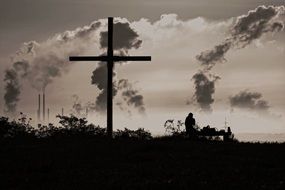 silhouette of the cross on a background of industry