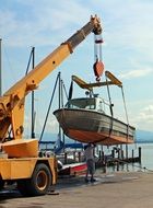 crane lifts the boat in the port