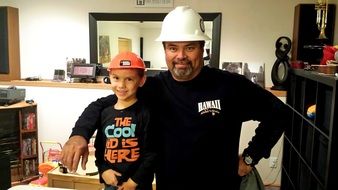 Happy son and father are construction workers