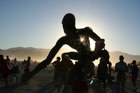 sculpture of a giant on a background of mountains