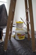 Stepladder and paint on the background of the room repair