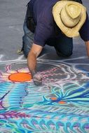 the artist draws with chalk