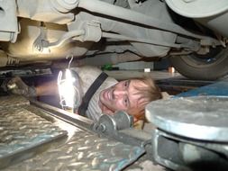 Car mechanic repairing car