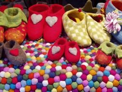 colorful handmade felt shoes on stand