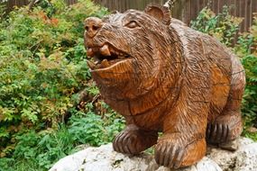 wooden bear sculpture in a garden