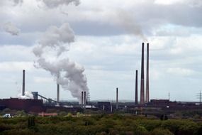 photo of the smoke coming from the chimneys of factories