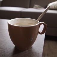 cup with spoon on table