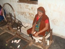 woman weaving on hand loom