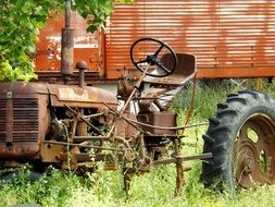 rusty abandoned tractor in tall grass