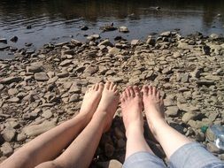 feet on a stone beach