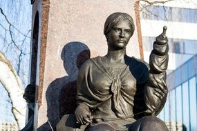 stone statue of a woman in the glare of light