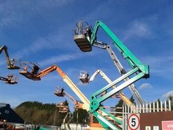 lifts of different colors against the blue sky