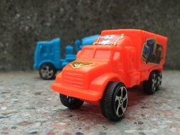 Two red and blue toy trucks