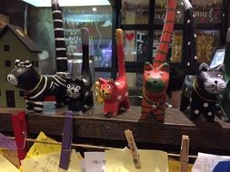 decorative multi-colored clay cats in the store