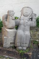 stone sculpture of grandmother and hen