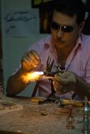 egyptian man making glass on furnace