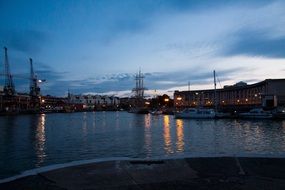 cranes and ships at port, evening landscape