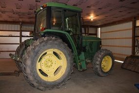 green tractor in the barn