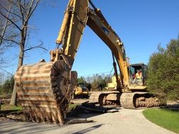 Backhoe working human in a park