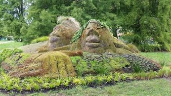 heads of ancient giants, mossy figures in garden, landscaping