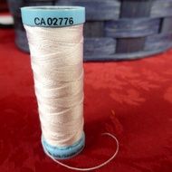 white sewing thread spool