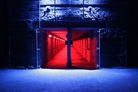 red illuminated passage in darkness