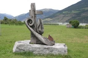wood carved artwork on meadow at mountains, italy, south tyrol