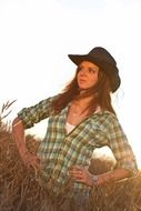 girl in a plaid shirt and a cowboy hat