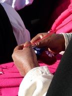 handmade traditional colorful bag in hands, peru