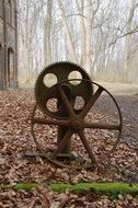abandoned rusted gears in autumn landscape
