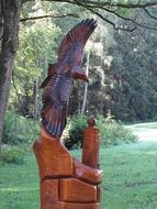 Sculpture of a bird of prey among the park