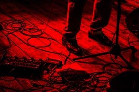 musician's legs on stage at a rock concert