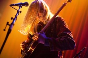 man playing guitar on stage