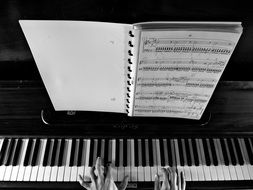 notebook with notes on the piano