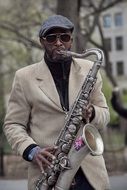 a man is playing the saxophone on the street