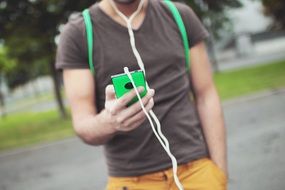 smartphone with headphones in hand