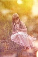 girl playing a pipe in the field