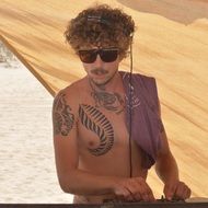 DJ in tattoos and sunglasses