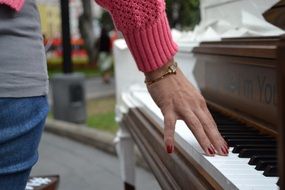 female hand on piano keys