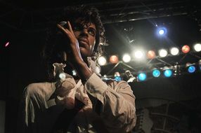 black musician on stage in the spotlights
