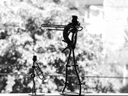 Black and white photo of the statuette at black and white blurred background