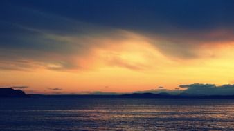 picturesque sunset behind the clouds over the sea