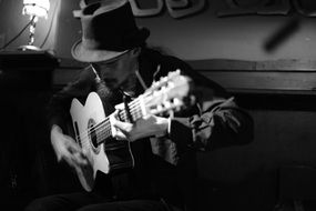 man in hat playing guitar