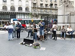 the musical group performs on a city street