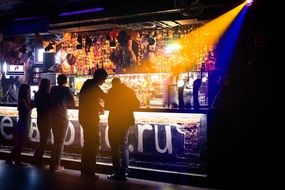 People stand near the bar