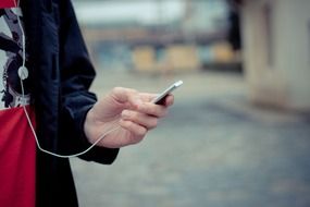 man's hand holding iPod