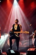 illuminated rock guitarist on stage